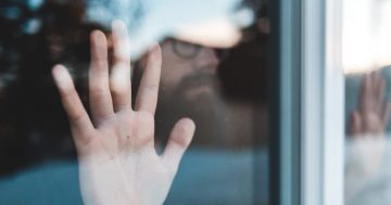 persons hand on glass window