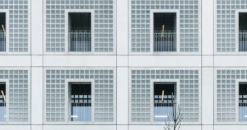 white concrete building with glass windows