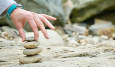 person piling brown stones