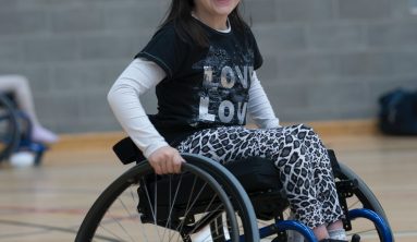 girl in black and white long sleeve shirt sitting on black wheelchair