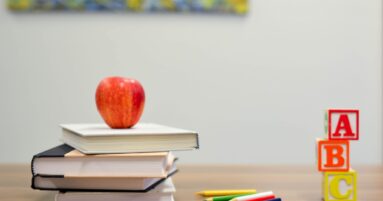 red apple fruit on four pyle books